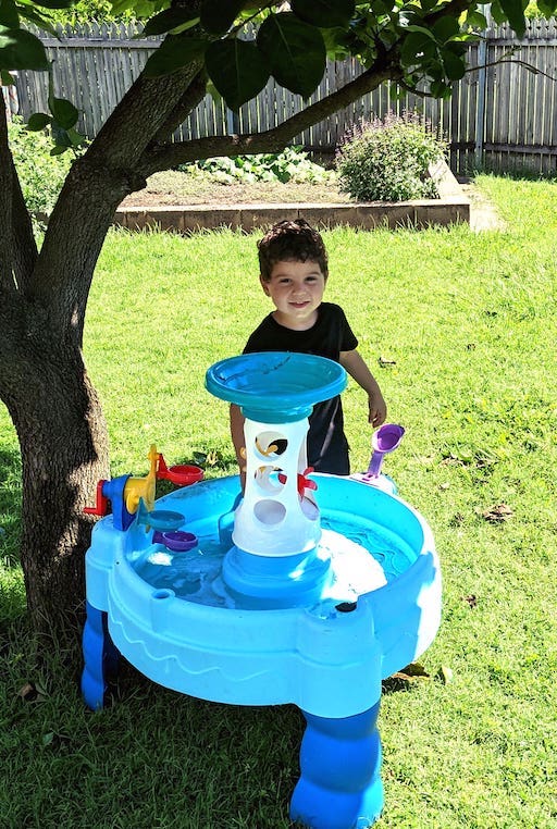 Splashing a Little Tikes water table.